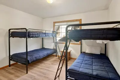 a room with two bunk beds and a window at Oriole House- Walk to Lake Chalet w/ Hot Tub in Big Bear Lake