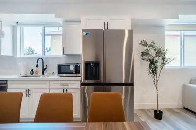 a kitchen with a stainless steel refrigerator at Chic & Comfortable Space Near Downtown LA & USC in Los Angeles