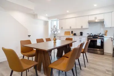 a kitchen with a wooden table and chairs at Stylish & Cozy Retreat Near USC & Downtown LA in Los Angeles