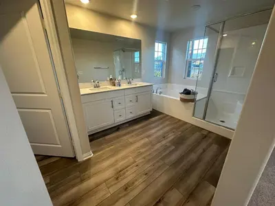 a bathroom with two sinks and a shower at 3 bed 3 Bath Gated Corner unit in Upland