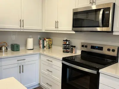 a kitchen with white cabinets and a microwave at 3 bed 3 Bath Gated Corner unit in Upland