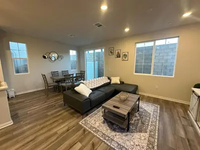 a living room with a couch and a table at 3 bed 3 Bath Gated Corner unit in Upland