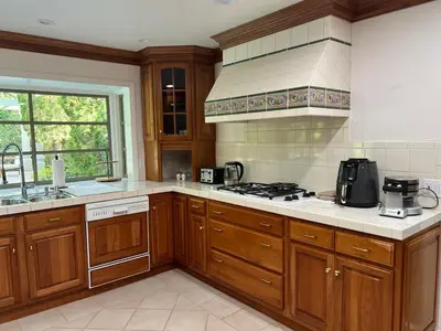 a kitchen with wooden cabinets and a stove top oven at Porter Paradise in Deer Lake Highlands