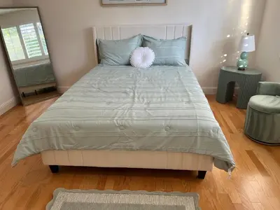 a bedroom with a bed with a pink pillow on it at Porter Paradise in Deer Lake Highlands