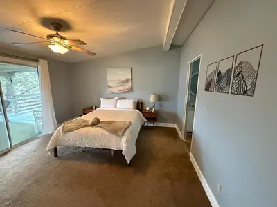 a bedroom with a bed and a ceiling fan at Scenic Lake House & Dog Friendly in Wofford Heights