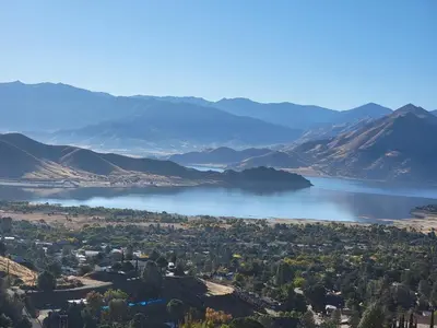 a lake in the middle of a valley with mountains at Scenic Lake House & Dog Friendly in Wofford Heights