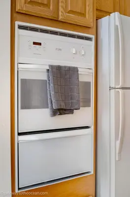 a white oven with a towel hanging from it at gateway to the ocean in Hawthorne