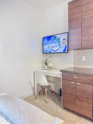 a room with a desk with a tv on the wall at Studio Luxury Marina del Rey with parking gym pool in Los Angeles