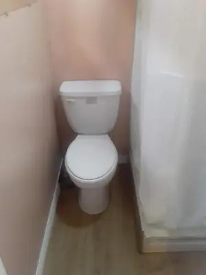 a bathroom with a white toilet in a corner at 2bd Home Lomita California spectacular location in Lomita