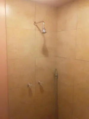 a shower with a glass door with a shower head at 2bd Home Lomita California spectacular location in Lomita