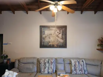 a living room with a couch and a ceiling fan at Private room furnished Cypress in Lomita