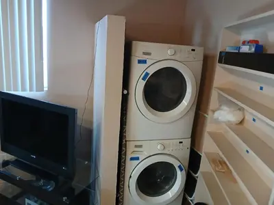 a washing machine and a tv in a room at Handcraft Cabin LAX Port of LA 20 min away in Lomita