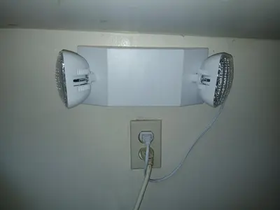 a lightswitch with a cord plugged into a wall at Handcraft Cabin LAX Port of LA 20 min away in Lomita