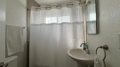 a white bathroom with a sink and a shower at Spacious 3BR 3BA Home Private Yard in Culver City in Los Angeles