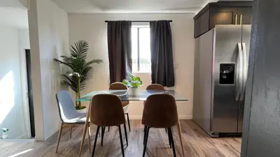 a dining room table with chairs and a refrigerator at Spacious 3BR 3BA Home Private Yard in Culver City in Los Angeles