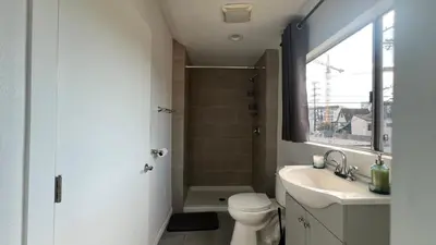 a bathroom with a toilet and a sink and a shower at Spacious 3BR 3BA Home Private Yard in Culver City in Los Angeles