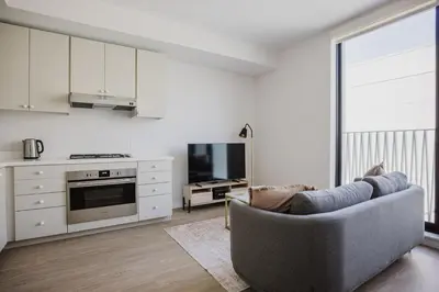 a living room with a couch and a tv at Blueground Downtown elevator nr The Broad LAX-1236 in Los Angeles