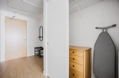 a room with a surfboard hanging on the wall at Blueground Downtown elevator nr The Broad LAX-1236 in Los Angeles