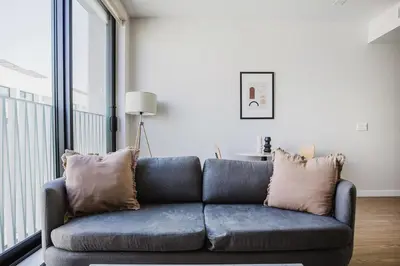 a blue couch with pillows in a living room at Blueground Downtown elevator nr The Broad LAX-1236 in Los Angeles