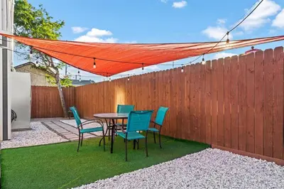 a patio with a table and chairs and a fence at Comfy 2 BR House near LAX, SOFI and Intuit Dome! in Inglewood