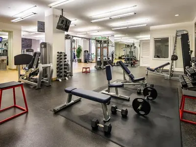 a gym with several treadmills and machines at Surfs up! Cozy 1 Bedroom Condo with Fountain View in Los Angeles