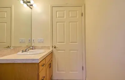 a bathroom with a sink and a white door at Malibu Home in Enchanting Hills 5 min from the beach in Malibu