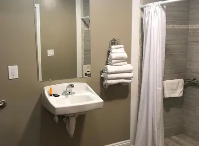 a bathroom with a sink and a shower at Corona inn in Corona