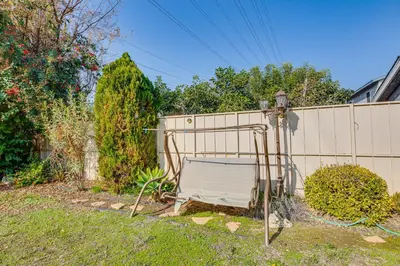 a chair in a yard next to a fence at 6 Mi to Dtwn Pasadena Home with Patio and Yard! in San Gabriel