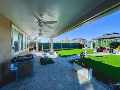 a patio with a fan and a lawn at California 3-Bedroom Desert Escape With Garden in Victorville