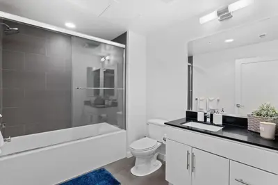 a white bathroom with a tub and a toilet and a sink at The rose-Spacious 3-Bedroom Retreat in the Heart of Marina del Rey in Los Angeles