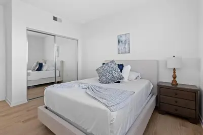 a white bedroom with a bed and a mirror at The rose-Spacious 3-Bedroom Retreat in the Heart of Marina del Rey in Los Angeles