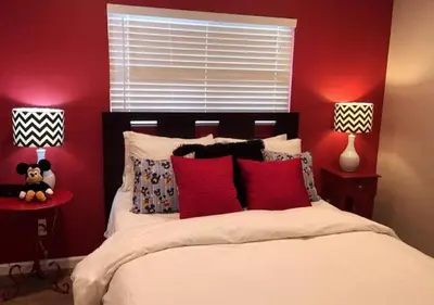 a bedroom with red walls and a bed with red pillows at MagicwayVillas Paradise Pier Home - Across Disney in Anaheim