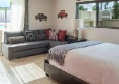 a bedroom with a bed and a couch at MagicwayVillas Cars Theme Pool House - Pool&Spa in Anaheim