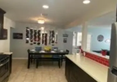 a large kitchen with a table in the middle of it at MagicwayVillas Cars Theme Pool House - Pool&Spa in Anaheim