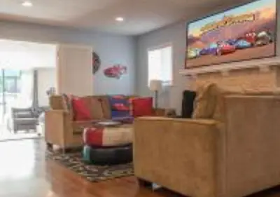 a living room with couches and a painting on the wall at MagicwayVillas Cars Theme Pool House - Pool&Spa in Anaheim