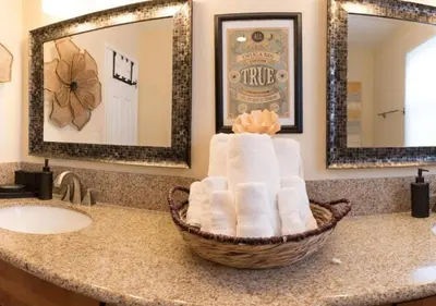 a bathroom with a basket of towels on a counter at MagicwayVillas LionQueen - Pool and Spa in Anaheim