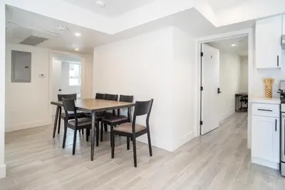 a kitchen and dining room with a table and chairs at Cozy LA Retreat Near USC Steps to Koreatown & Downtown in Los Angeles