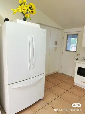 a white refrigerator in a kitchen with a vase of flowers at New renovated room with shared bathroom in Hacienda Heights