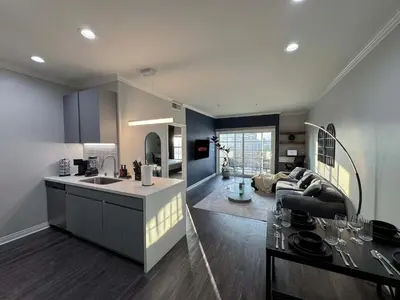 a kitchen and a living room with a couch at Bright & Spacious in Iconic LA Neighborhood Free parking - 10mins to Cedars in Los Angeles