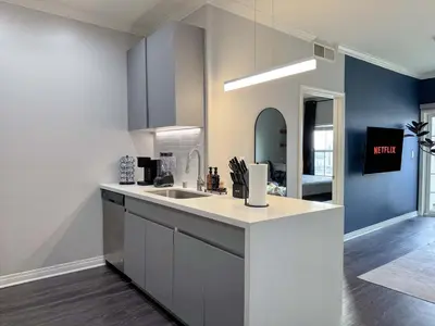 a kitchen with a sink and a counter top at Bright & Spacious in Iconic LA Neighborhood Free parking - 10mins to Cedars in Los Angeles