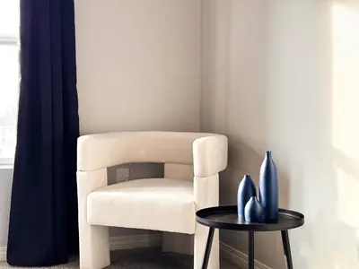 a white chair in a corner with a table at Bright & Spacious in Iconic LA Neighborhood Free parking - 10mins to Cedars in Los Angeles