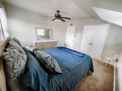 a bedroom with a bed and a ceiling fan at Cozy 4BR home near SoFi in the City Of Champions in Inglewood