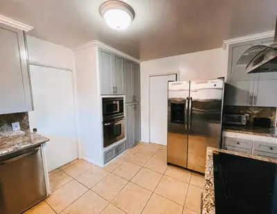 a large kitchen with a stainless steel refrigerator at Cozy 4BR home near SoFi in the City Of Champions in Inglewood