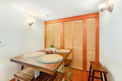a dining room with a wooden table and chairs at Calm Cozy 3BR cabin wAC, WiFi, Parking, BBQ in Cedar Glen