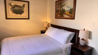 a bedroom with a bed and two pictures on the wall at Private Room and Bathroom in Los Angeles