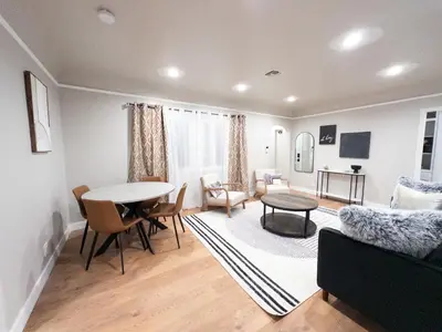 a living room with a table and a couch at Stylish & Cozy Retreat in the Heart of LA in Los Angeles
