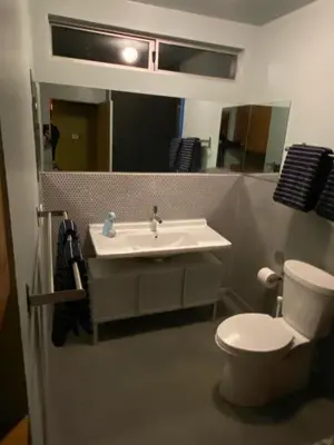 a bathroom with a sink and a toilet and a mirror at The Bernardi House in Los Angeles