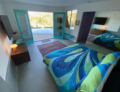 a bedroom with a bed and a mirror at The Bernardi House in Los Angeles