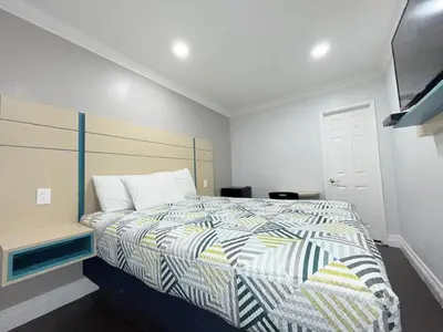 a bedroom with a bed with a striped comforter at Uptown Inn in Long Beach