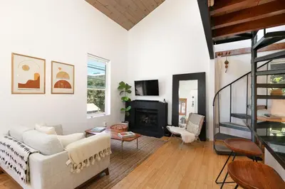 a living room with a white couch and a fireplace at Private Venice Beach Loft - Steps to the Beach & Canals in Los Angeles